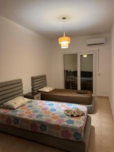 a bedroom with two beds in a room at Luxueuse à Marina Saidia in Saïdia +16 photos