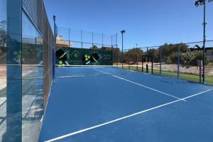 a tennis court with a net on top of it at Olive Sun Villa Stillness & Elegance by etouri in Kato Gouves