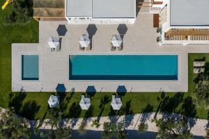 an overhead view of a swimming pool in a yard at Olive Sun Villa Stillness & Elegance by etouri in Kato Gouves
