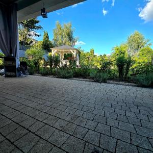 a patio with a gazebo in a yard at Miejski zakątek in Zielona Góra