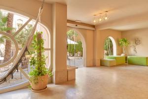 an empty lobby with a staircase and plants at Captain's Inn Hotel in Hurghada