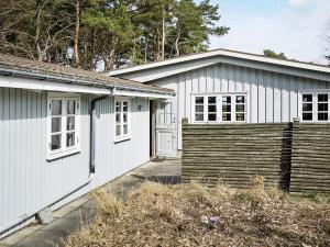 a white house with a white door and a yard at Modern Beachfront Retreat - By Traum Ferienwohnungen in Balke
