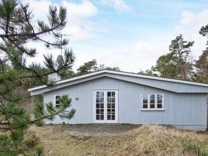 a white house with trees in the background at Modern Beachfront Retreat - By Traum Ferienwohnungen in Balke
