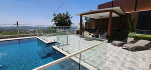 a house with a swimming pool with a view at The Three Angels Suites in ‘Ein el Asad