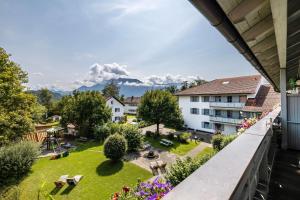 a view of the garden from the balcony of a hotel at Fewo Brünnstein - Nr 61 Pool, Sauna in Oberaudorf
