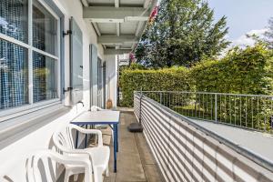 a table and chairs on the balcony of a house at Fewo Brünnstein - Nr 5 Pool, Sauna in Oberaudorf