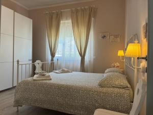 ein kleines Schlafzimmer mit einem Bett und einem Fenster in der Unterkunft Piano terra con giardino, vicino al mare in Viareggio