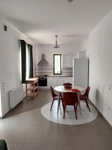 a kitchen with a table and chairs and a refrigerator at Horizon in Kýthira