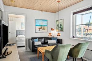 a living room with a couch and a table at 4135-Borre-Klintholm-Havneby-35-st in Borre
