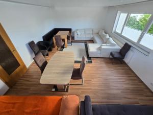 a conference room with tables and chairs and a couch at Apartment Bergblick Bad Berleburg in Bad Berleburg