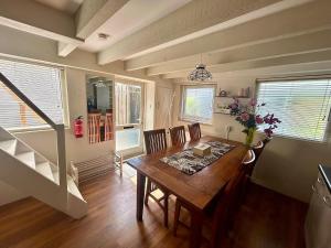 a dining room with a wooden table and chairs at La Casetta in Malden