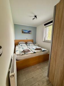 a small bedroom with a bed in a room at Apartments Kolačko in Bohinj