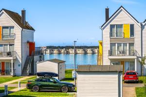 a green car parked in front of some houses at Ferienwohnung Nicks Seestern Olpenitz in Olpenitz