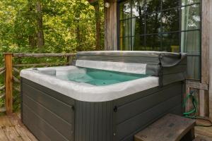 a hot tub on the deck of a house at Laurel Valley Mountain Retreat in Townsend