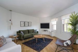 a living room with a couch and a table at Beautiful Modern Bright 2bd Patio Duplex #179 in Istanbul