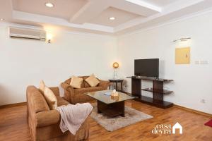 a living room with a couch and a tv at Nova Suite 3BHK Apartment in Kathmandu