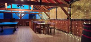a dining room with tables and chairs and lights at Green Hill in Jesenice na Dolenjskem