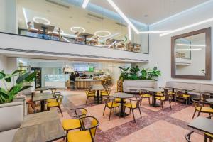a restaurant with tables and chairs and a bar at Ingate Hotel in Famagusta
