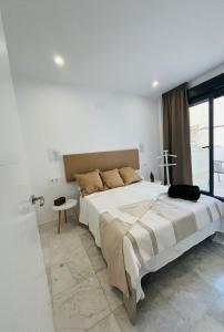 a bedroom with a large bed and a window at La Cabane Fuengirola in Fuengirola +16 photos
