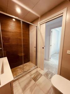 a shower with a glass door in a bathroom at La Cabane Fuengirola in Fuengirola