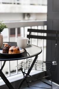 a table with a cup of coffee and a pastry on it at Skyline Cube in Thessaloniki