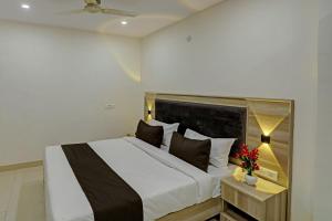 a bedroom with a large bed and a table with flowers at Townhouse DSR SECTOR 19 in Noida