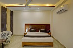 a bedroom with a bed and a ceiling fan at Townhouse DSR SECTOR 19 in Noida