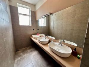 a bathroom with three sinks and a mirror at 234 Weligama in Weligama +33 photos