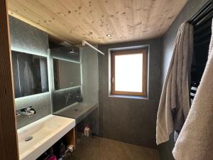 a bathroom with a sink and a mirror and a window at CHALET ALIET 1500 - 18 personnes PEISEY NANCROIX - LES ARCS - LA PLAGNE - PARADISKI in Peisey-Nancroix +35 photos