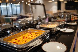 a buffet with several trays of food on a table at PINEA Resort in Pobierowo