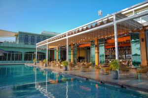 a hotel with a swimming pool and a restaurant at My Beach Resort Phuket, Panwa Beach in Panwa Beach