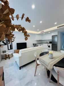 a living room with a couch and a table at La Cabane Fuengirola in Fuengirola