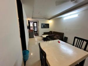 a dining room with a table and a couch at GetawayZ Rishikesh - 1BHK Luxury Flat - Tapovan 1BHK in Rishīkesh