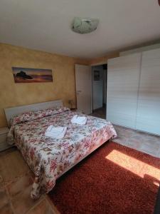 a bedroom with a bed with two phones on it at STELLA MARINA, Appartamento a 450 mt dalla costa del Mar di Sardegna in Portoscuso