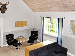 a living room with two chairs and a table at 6 person holiday home in LJUNG-By Traum in Alboga