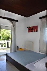 a bedroom with a bed and a window with a view at Villa Esperado Gardens Maleme in Maleme