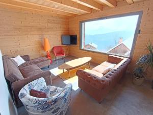 a living room with a couch and a table at Chalet de l'Aiguille Noire in Montricher-Albanne