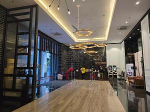 a lobby with a wooden table in a building at Chamber Residences KL At EZ Stay in Kuala Lumpur +37 photos