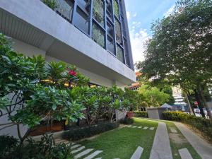 a building with a garden in front of it at Chamber Residences KL At EZ Stay in Kuala Lumpur