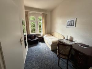a living room with a couch and a table at Hotel Carolinenhof in Bad Pyrmont