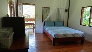 a bedroom with a bed in a room at Cha Bungalow in Ko Yao Noi