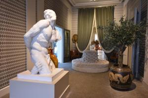 a statue of a woman standing in a room at Hotel Van Cleef in Bruges