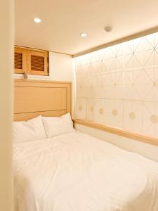 a bedroom with a large white bed in it at Stay 42 Dongmyo in Seoul