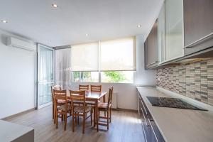 a kitchen with a table and chairs in a room at Casa Potelos by Concept Flats in Navajas