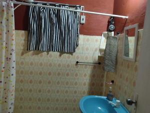 a bathroom with a blue sink and a shower curtain at Miraflores 2- Calor de Hogar in Asuncion +14 photos