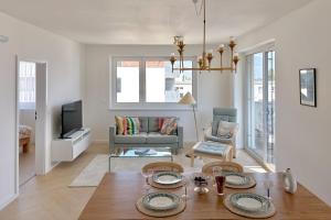 a living room with a table and a couch at Shiny Stay with Balcony & Private Parking in Koliba