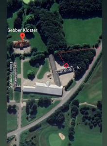 a map of a mansion with a red arrow pointing to a house at Sebber Kloster in Nibe