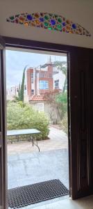 an open door to a patio with a bench outside at Artel luxury Suits in Al Qirrān
