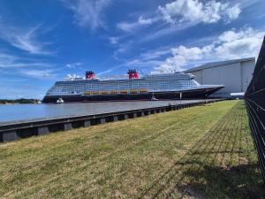 a cruise ship is docked at a dock at Ferienwohnung Fehnzauber, 86005 in Ostrhauderfehn