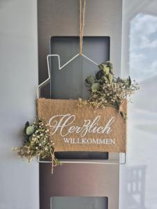 a sign on the side of a building at Ferienwohnung Fehnzauber, 86005 in Ostrhauderfehn